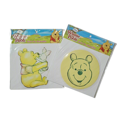 Two packages of Winnie-the-Pooh iron on transfers, one depicting Winnie-the-Pooh holding a honey pot and the other with Winnie-the-Pooh's face silhouette.